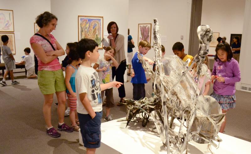 A group of children looks at a sculpture in an art museum