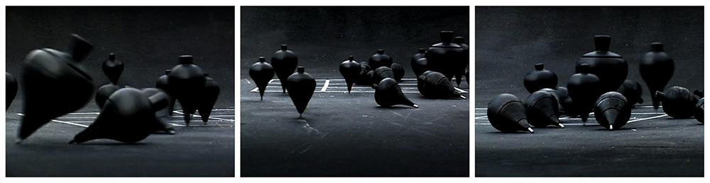 black sculptures scattered across black floor