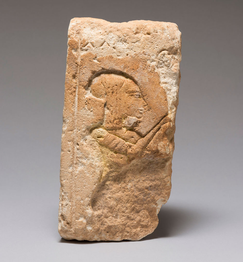 relief carving of a person in sandstone