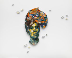 A woman in a colorful headwrap in the shape of Africa
