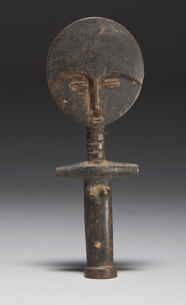 A brown wooden fertility figure of a woman with a large round head