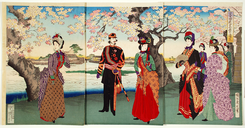 A row of people in brightly colored clothing standing under blossoming cherry trees